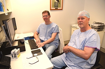 Two male clinicians seated at a table